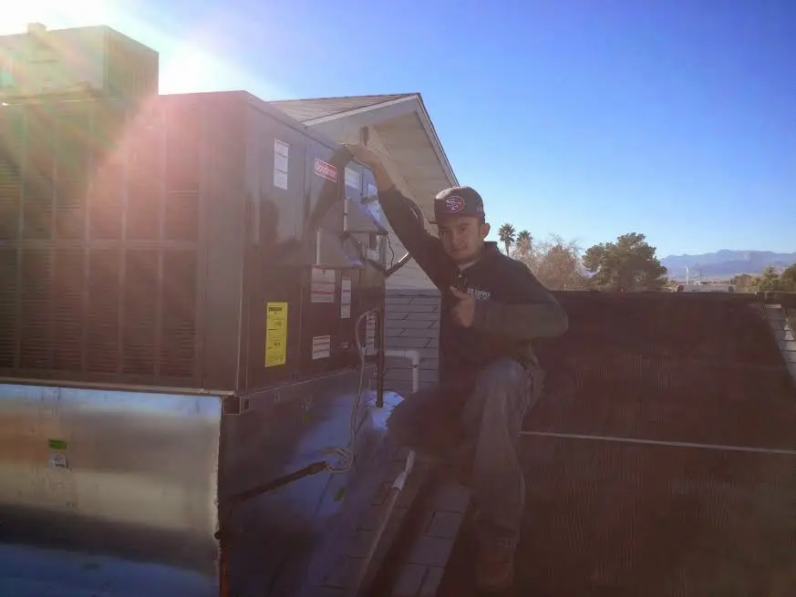 HVAC technician performing Boiler Repair on a rooftop unit in Ballenger Creek